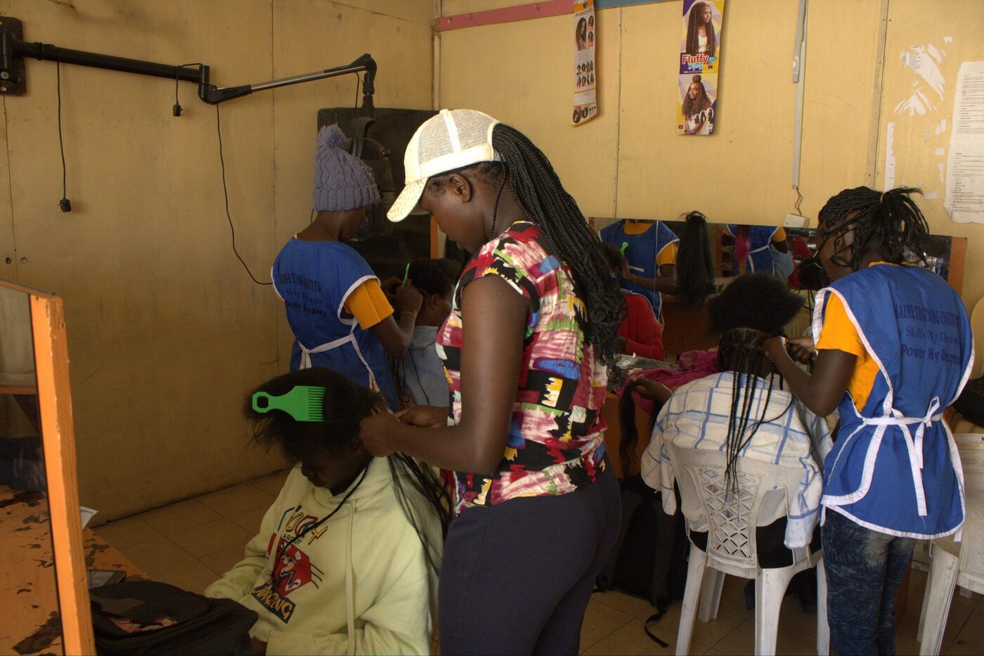 Cosmetology trainees practising hairdressing at Germaine